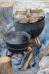 black kettle for campfire on tripod