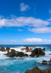 Turquoise waves crashing against the rock-pools, northern Madeira island, Portugal.