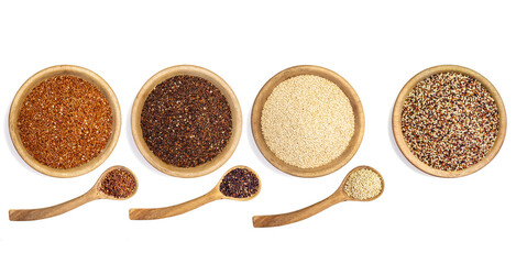 White, red and black quinoa in wooden bowls and spoons, overhead image with white background.