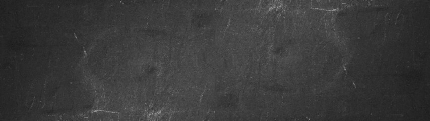 Black grey anthracite stone concrete scratched weathered grunge wall or floor texture background panorama banner long