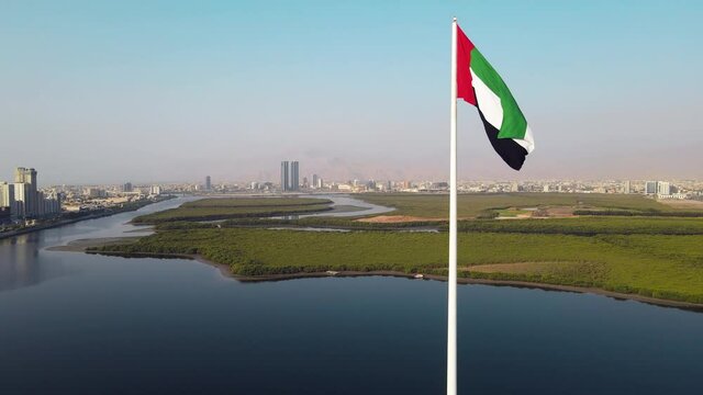 UAE flag and Ras al Khaimah emirate in the north United Arab Emirates aerial skyline landmark view
