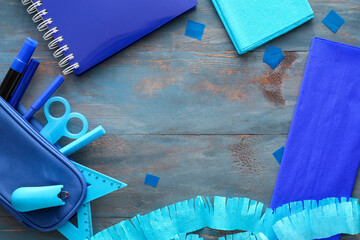 Frame made of materials for making Mexican pinata on blue wooden background