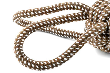 Macro photo of a brown rope with white details made of cotton and jute, isolated on a white background.