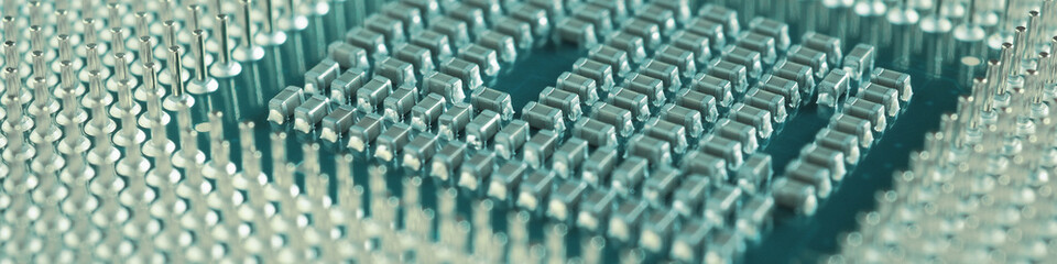 Computer processor close-up. Turquoise tinted banner. Information technology teal headline. A pattern of contacts and semiconductors of a PC microprocessor. Macro