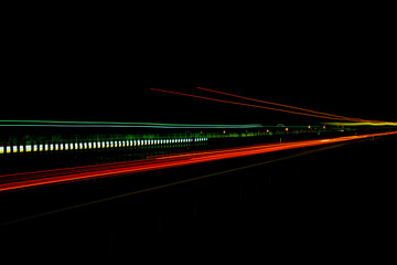 Night road lights. Lights of moving cars at night. long exposure red, blue, green