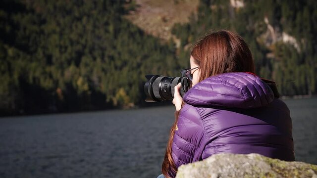 Female photographer at mountain lake in Aiguestortes National Park, Catalonia, Spain.
Parallax camera movement, mid angle, hd.
