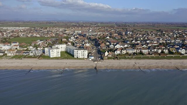 The seaside village of East Wittering aerial footage from the sea towards this popular destination for tourists in the English summer.
