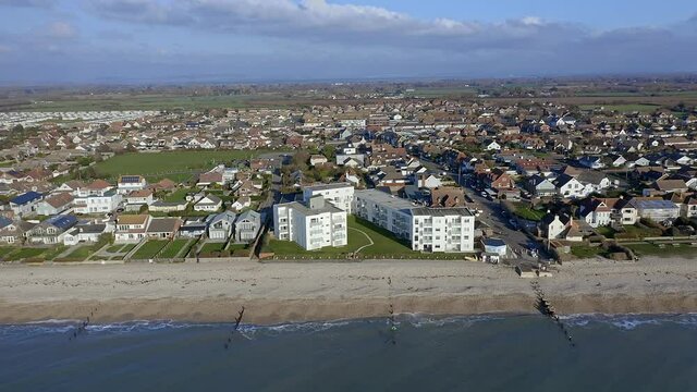 Aerial footage along the seafront of East Wittering, a seaside village in Southern England and popular with tourists in the summer.
