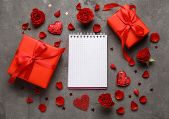 Romantic composition with empty notebook and gifts on grunge background