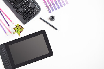 Modern designer workspace with graphic tablet, monitor, keyboard, succulent plant on white...
