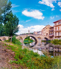 Valderrobres, Spain - July 7, 2021: Stone bridge over the river makes the entrance to the old medieval city of Valderrobres.