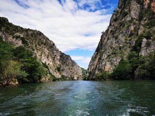 Naklejka na ściany i meble Lake in the Matka canyon - Macedonia. Mountains, emerald water, motor boats. Landscape without people