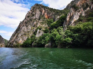 
Lake in the Matka canyon - Macedonia. Mountains, emerald water, motor boats. Landscape without people - obrazy, fototapety, plakaty