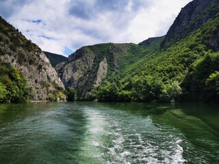 
Lake in the Matka canyon - Macedonia. Mountains, emerald water, motor boats. Landscape without people - obrazy, fototapety, plakaty