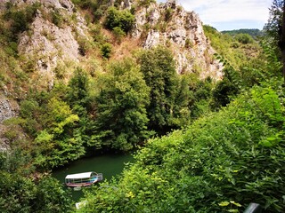 
Lake in the Matka canyon - Macedonia. Mountains, emerald water, motor boats. Landscape without people - obrazy, fototapety, plakaty