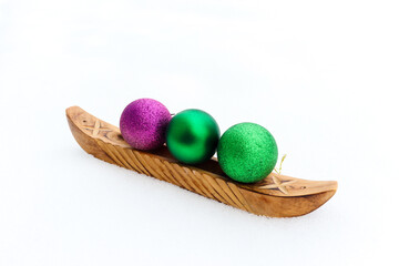 Boat made of wood sailing on snow with tree Christmas green and purple balls, isolated on white background