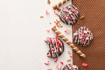 Tasty candy cane cookies on light background