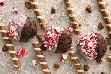 Tasty candy cane cookies on light background