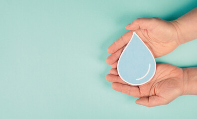 Hands holding a drop of water, paper cut out, environmental issue, world water day