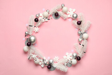 Frame made of Christmas decor on pink background