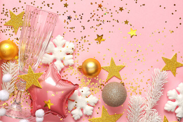 Beautiful Christmas composition with decor and glass on pink background