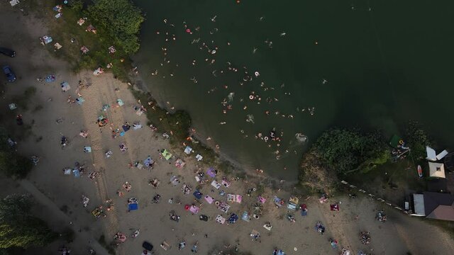 drone movement along a beach full of people