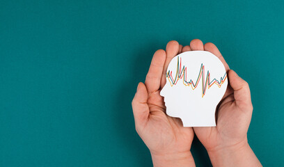 Holding a head in the hands, mental health concept, alzheimer and epilepsy disorder, brain waves, paper cut out - obrazy, fototapety, plakaty