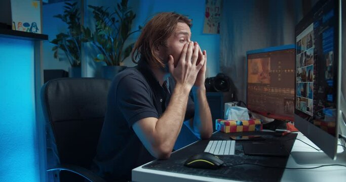 Young freelance man digital content editor working using computer feeling bad having headache or illness. Concept of home office or distancing job. Online surfing searches for footages in stock market