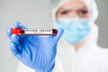 Doctor medical worker holding test tube specimen holder containing Omicron variant Coronavirus...