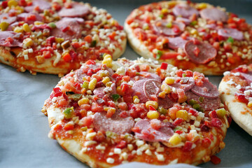 frozen pizza in a baking tray, ready pizza, frozen foods,