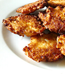 close-up pan fried cauliflower,fried cauliflower patties in plate,