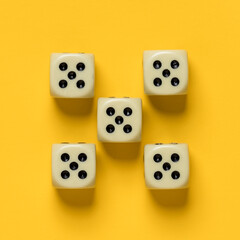 Ideally placed dice, their number and value are the same, on a yellow background. Top view. 