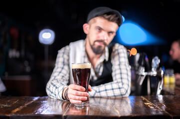 Charismatic barkeeper demonstrates his professional skills in cocktail bars