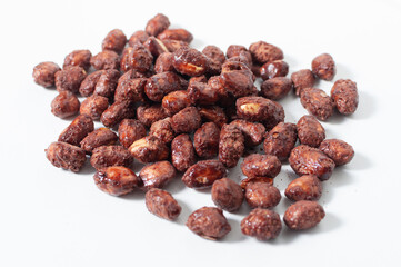Some peanuts praline sweet on white table or background.