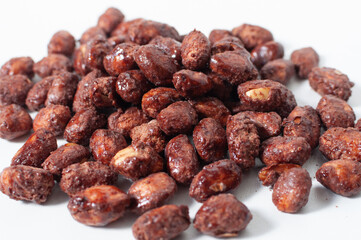 Close-up view of some peanuts praline sweet on white table or background.