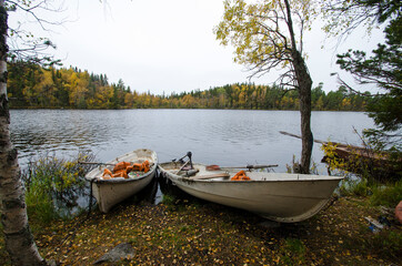 Wooden boats on the shore of an autumn lake 