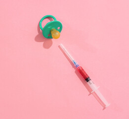 Syringe with injection and pacifier soother for baby, children treatment concept