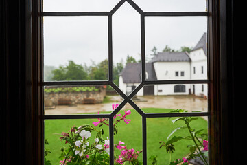 Closeup view from historic window  from medieval age to the courtyard of quadrangle of castle Nove hrady in southern region of Bohemia in Czech republic, one of most beautiful castles from middle ages