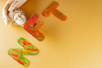 NFT Non-Fungible token . Artificial fingers hug the plaster head of Hermes. NFT inscription on a...