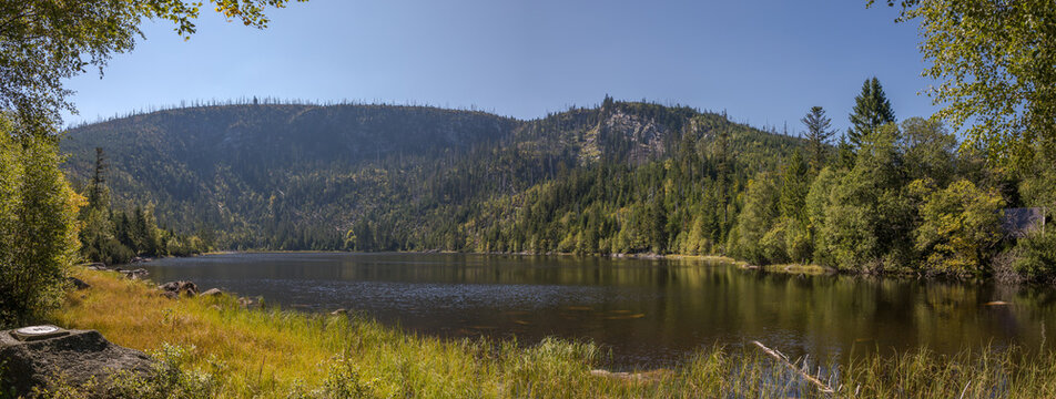 &Scaron;umava glacial lake and view of a mountain ridge