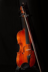 Fototapeta na wymiar Beautiful violin forgotten in the dark just waiting to be able to make music