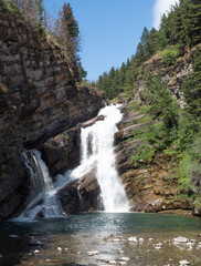 Cameron Falls Pouring Over Rocky Cliff in Waterton Village, Alberta, Canada