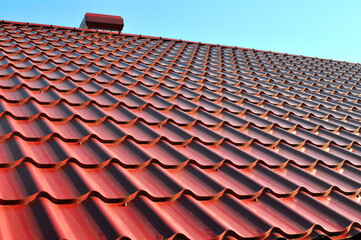 The roof of the house is covered with metal tiles