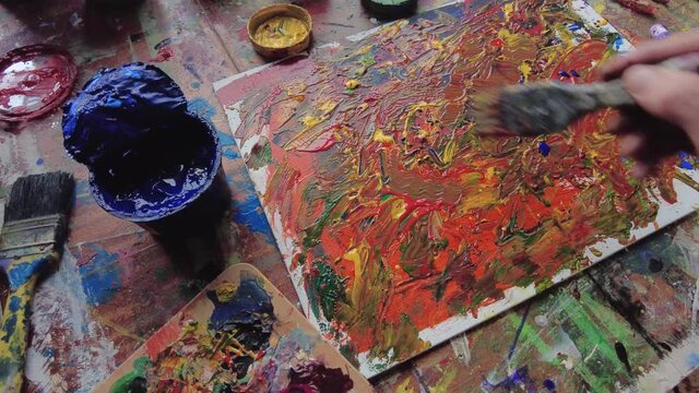 Painter in workspace creating modern art