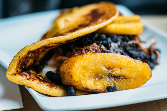 Venezuelan cachapa of fried corn dough stuffed with pork rinds and fresh cheese