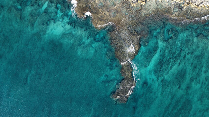 Aerial view of cliffs near a blue sea