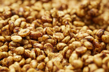 Close-up shot of a pile of raw fresh coffee beans during the honey processing