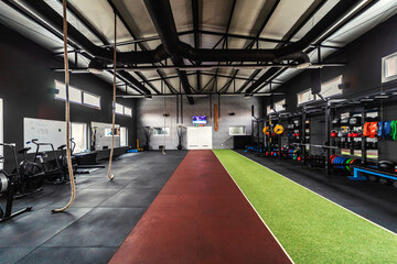 Interior of an urban gym with equipment. Sports center for a cross fit, aerobic, spinning class,...