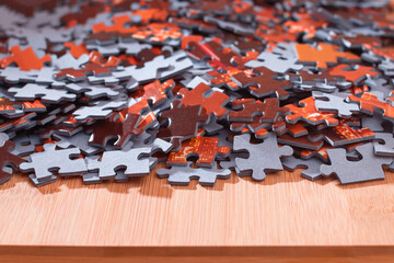 Colorful Peaces of a Mixed Jigsaw Puzzle Lie on the Wooden Table - Strategy and Solving Problem Concept