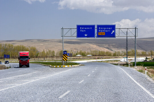 Street signs on this East Anatolian highway in Turkey give directions to the cities of Edremit, Van, Gurpinar, and Hakkari, as well as to the Turkish border with Iran